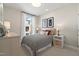 Bright bedroom featuring neutral walls, patterned bedding, and stylish bedside tables with lamps at 1501 Village Hall Ln # 38, Wake Forest, NC 27587