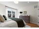 Modern bedroom featuring a comfortable bed, wooden dresser, and a large window with natural light at 1501 Village Hall Ln # 38, Wake Forest, NC 27587