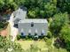 Stunning aerial view of a two-story home with a well-manicured lawn and mature trees at 1610 Ridge Rd, Raleigh, NC 27607