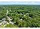Aerial view of a leafy residential neighborhood with lush green trees and homes at 1610 Ridge Rd, Raleigh, NC 27607