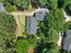 Aerial view of home showcasing its mature trees, patio and outdoor living space at 1610 Ridge Rd, Raleigh, NC 27607