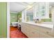 Stylish bathroom with a soaking tub, double vanity, and elegant green wallpaper at 1610 Ridge Rd, Raleigh, NC 27607