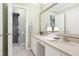 Bathroom with double sinks, marble floors, and walk-in shower at 1610 Ridge Rd, Raleigh, NC 27607
