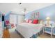 Light and bright bedroom with blue walls, white furnishings, and a ceiling fan at 1610 Ridge Rd, Raleigh, NC 27607