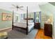 Spacious bedroom features a four poster bed, ceiling fan, and ensuite bathroom at 1610 Ridge Rd, Raleigh, NC 27607