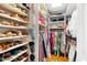 Well-organized walk-in closet with shelves for shoes and hanging space for clothing at 1610 Ridge Rd, Raleigh, NC 27607