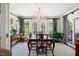 Elegant dining room features a chandelier and windows with lush outdoor views at 1610 Ridge Rd, Raleigh, NC 27607