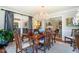 The dining room features a gorgeous chandelier and access to outdoor seating at 1610 Ridge Rd, Raleigh, NC 27607