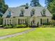 Charming front exterior with a landscaped yard and a walkway leading to the entrance at 1610 Ridge Rd, Raleigh, NC 27607