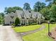 Attractive two-story house boasting a well-kept lawn, stone walkway, and a welcoming front facade at 1610 Ridge Rd, Raleigh, NC 27607