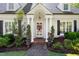 Close up of the front door framed with decorative columns and manicured greenery at 1610 Ridge Rd, Raleigh, NC 27607