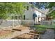 Backyard garden area with raised garden beds and a charming white picket fence, adjacent to the home at 1610 Ridge Rd, Raleigh, NC 27607