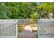 Backyard garden area with raised beds and a white picket fence for a charming aesthetic at 1610 Ridge Rd, Raleigh, NC 27607
