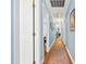 Long hallway with wood floors and light blue walls at 1610 Ridge Rd, Raleigh, NC 27607