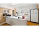Functional kitchen with ample counter space and lots of natural light, featuring white cabinetry at 1610 Ridge Rd, Raleigh, NC 27607
