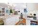 This kitchen features stainless steel appliances, white cabinets, and a large island at 1610 Ridge Rd, Raleigh, NC 27607