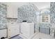 Laundry room with floral wallpaper, washer and dryer, sink, and window at 1610 Ridge Rd, Raleigh, NC 27607
