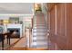 Warm living room featuring a fireplace, staircase, and access to other rooms at 1610 Ridge Rd, Raleigh, NC 27607