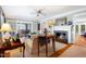 Comfortable living room featuring a fireplace, large windows, and open access to the dining room at 1610 Ridge Rd, Raleigh, NC 27607