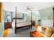 Spacious main bedroom with a four-poster bed, blue accents, and ample natural light at 1610 Ridge Rd, Raleigh, NC 27607