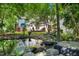 Backyard pond with landscaping, creating a serene and natural oasis at 1610 Ridge Rd, Raleigh, NC 27607