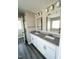 Bathroom featuring dual sinks with granite countertops and modern lighting fixtures at 1618 Brownairs Ln, Raleigh, NC 27610