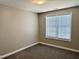 Bedroom features neutral paint, plush carpet, and a bright window at 1618 Brownairs Ln, Raleigh, NC 27610