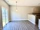 Dining area featuring modern light fixture and sliding glass door to the yard at 1618 Brownairs Ln, Raleigh, NC 27610