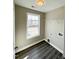 Laundry room with black wood flooring and a window for natural light at 1618 Brownairs Ln, Raleigh, NC 27610