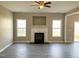 Bright living room featuring a fireplace, modern flooring, and ample natural light at 1618 Brownairs Ln, Raleigh, NC 27610