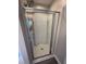Bathroom shower with framed glass door and built in shelving at 1618 Brownairs Ln, Raleigh, NC 27610
