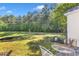 A backyard with a well-kept lawn, surrounded by trees and foliage at 1725 T W Alexander Dr # 204, Durham, NC 27703