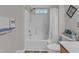 Bathroom featuring a shower-tub combo with white tiling and stylish decor at 1725 T W Alexander Dr # 204, Durham, NC 27703