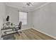 Bright bedroom featuring wood floors, gray walls, and a modern desk with computer at 1725 T W Alexander Dr # 204, Durham, NC 27703