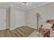 Bedroom featuring wood floors, gray walls, a closet, and a recliner at 1725 T W Alexander Dr # 204, Durham, NC 27703