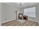 Bedroom featuring wood floors, gray walls, a recliner, and a small end table at 1725 T W Alexander Dr # 204, Durham, NC 27703