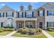 Charming townhome exterior featuring a stone facade, dormer windows and manicured landscaping at 1725 T W Alexander Dr # 204, Durham, NC 27703