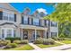Charming townhome exterior featuring a stone facade, dormer windows and manicured landscaping at 1725 T W Alexander Dr # 204, Durham, NC 27703