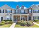 Charming townhome exterior featuring a stone facade, dormer windows and manicured landscaping at 1725 T W Alexander Dr # 204, Durham, NC 27703