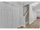 Well-lit hallway with wood floors, leading to the staircase and featuring ample closet space at 1725 T W Alexander Dr # 204, Durham, NC 27703