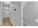 Bright hallway with wood floors featuring access to a half bathroom and a staircase at 1725 T W Alexander Dr # 204, Durham, NC 27703