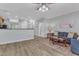 Open-concept living room boasts hardwood style flooring, a ceiling fan, and a comfortable sofa at 1725 T W Alexander Dr # 204, Durham, NC 27703