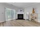Bright living room with sliding glass doors, fireplace, and hardwood style flooring at 1725 T W Alexander Dr # 204, Durham, NC 27703