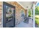 Inviting covered front porch with stone accents and rocking chairs, creating a cozy entry at 1725 T W Alexander Dr # 204, Durham, NC 27703