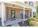 Inviting covered front porch with stone accents and rocking chairs, creating a cozy entry at 1725 T W Alexander Dr # 204, Durham, NC 27703