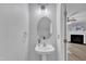 Stylish powder room boasts pedestal sink, modern lighting, and neutral tones at 1725 T W Alexander Dr # 204, Durham, NC 27703