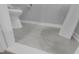 Powder room featuring grey tile floors, a pedestal sink, and a toilet at 1725 T W Alexander Dr # 204, Durham, NC 27703
