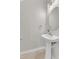 Chic powder room with pedestal sink, vanity mirror, and updated fixtures at 1725 T W Alexander Dr # 204, Durham, NC 27703
