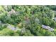 Aerial view of a home nestled in the trees surrounded by dense foliage at 1952 Lewis Dr, Burlington, NC 27215