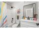 Bright white bathroom with a modern vanity, decor, and shower/tub combo at 1952 Lewis Dr, Burlington, NC 27215
